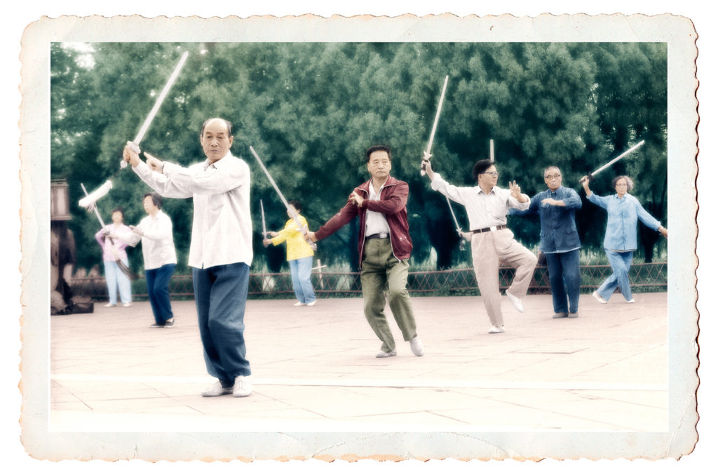 Hand-tinted photo of early morning Tai Chi sword class in China