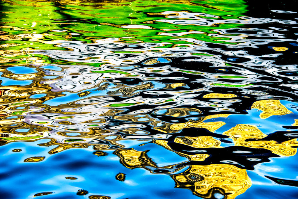 Colour Photograph of rippling circles of reflection